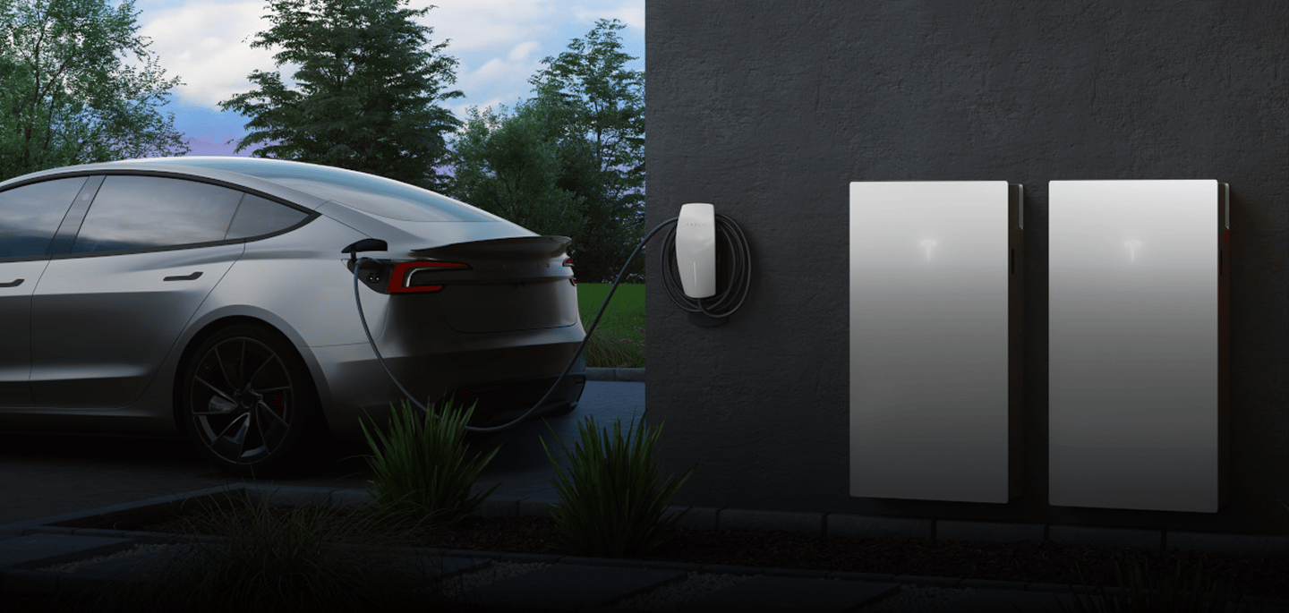 Tesla charging at home beside two wall-mounted Powerwalls