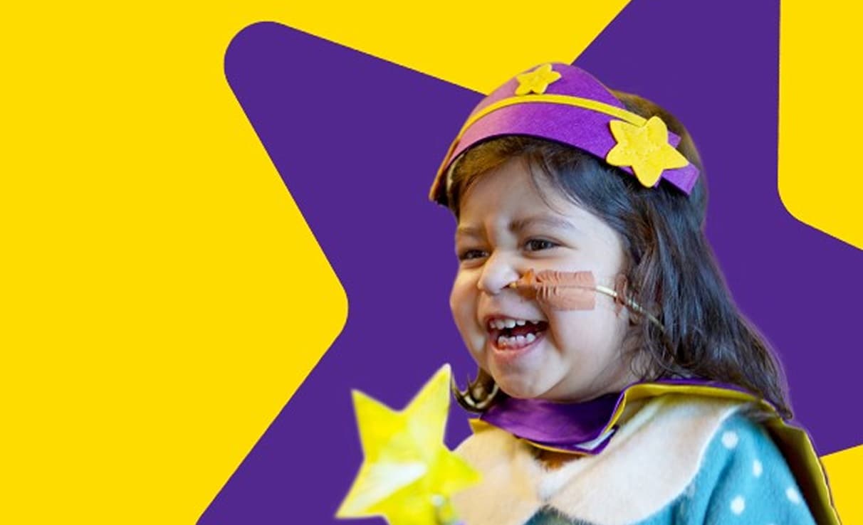 Child smiling with a star headband